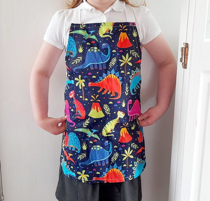 Kids aprons handmade in the UK. Dinosaur aprons for kids. Dino apron for adults. Teenager gift ideas.
