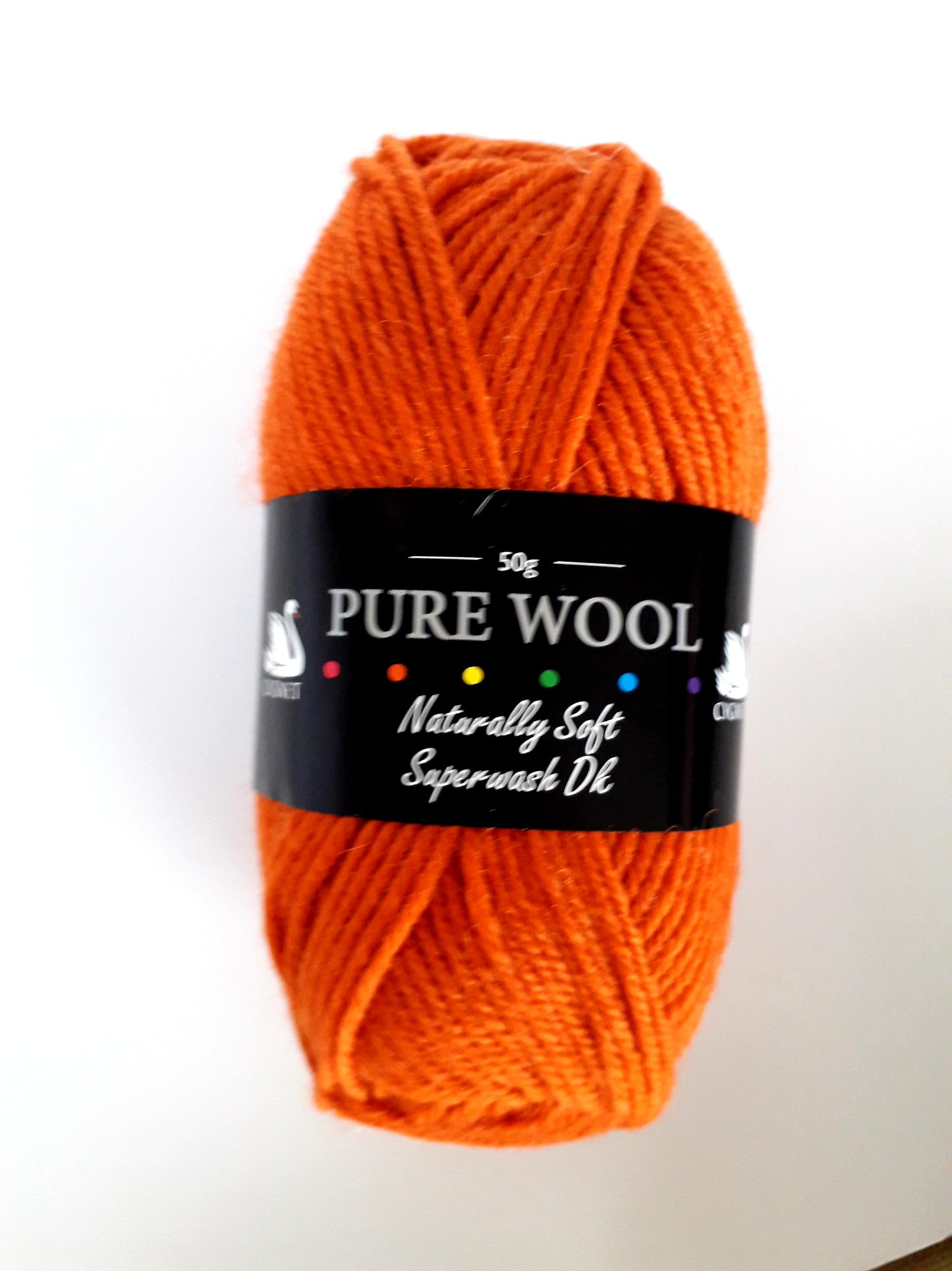 A bright rusty orange coloured ball of wool yarn