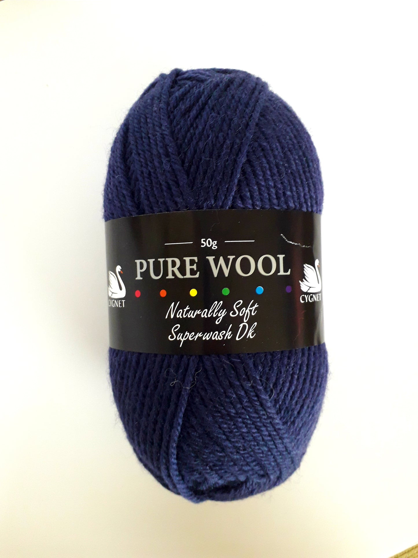 A navy blue coloured ball of wool stands before a white background