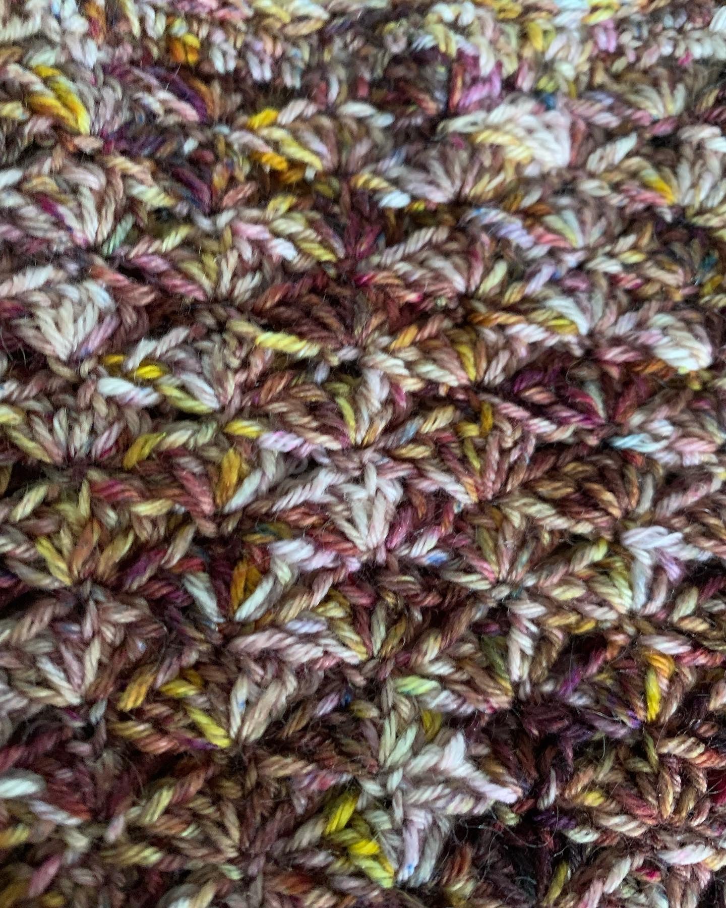 Close up of an easy beginner crochet scarf using a variegated yarn. 