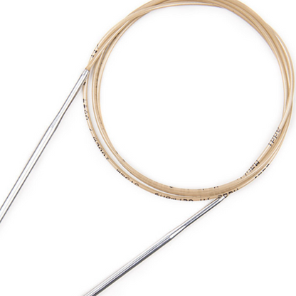 Imahe shows a close up of the addi turbo fixed circular knitting needles with a gold cord. 