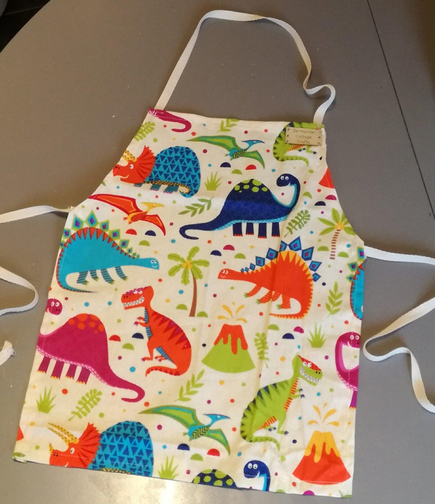 Dinosaur aprons for children. Fun kids apron designs. Kids dino apron. 