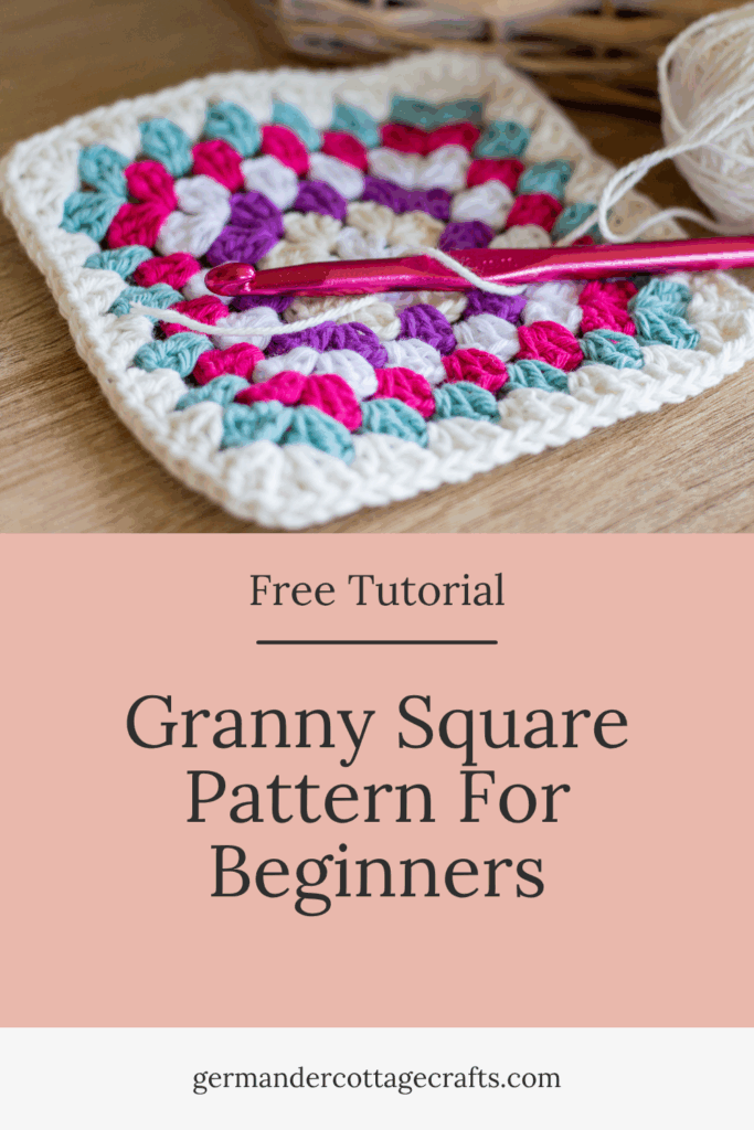 Free Granny Square Crochet Pattern For Beginners. Image shows a granny square with a crochet hook resting on it. 
